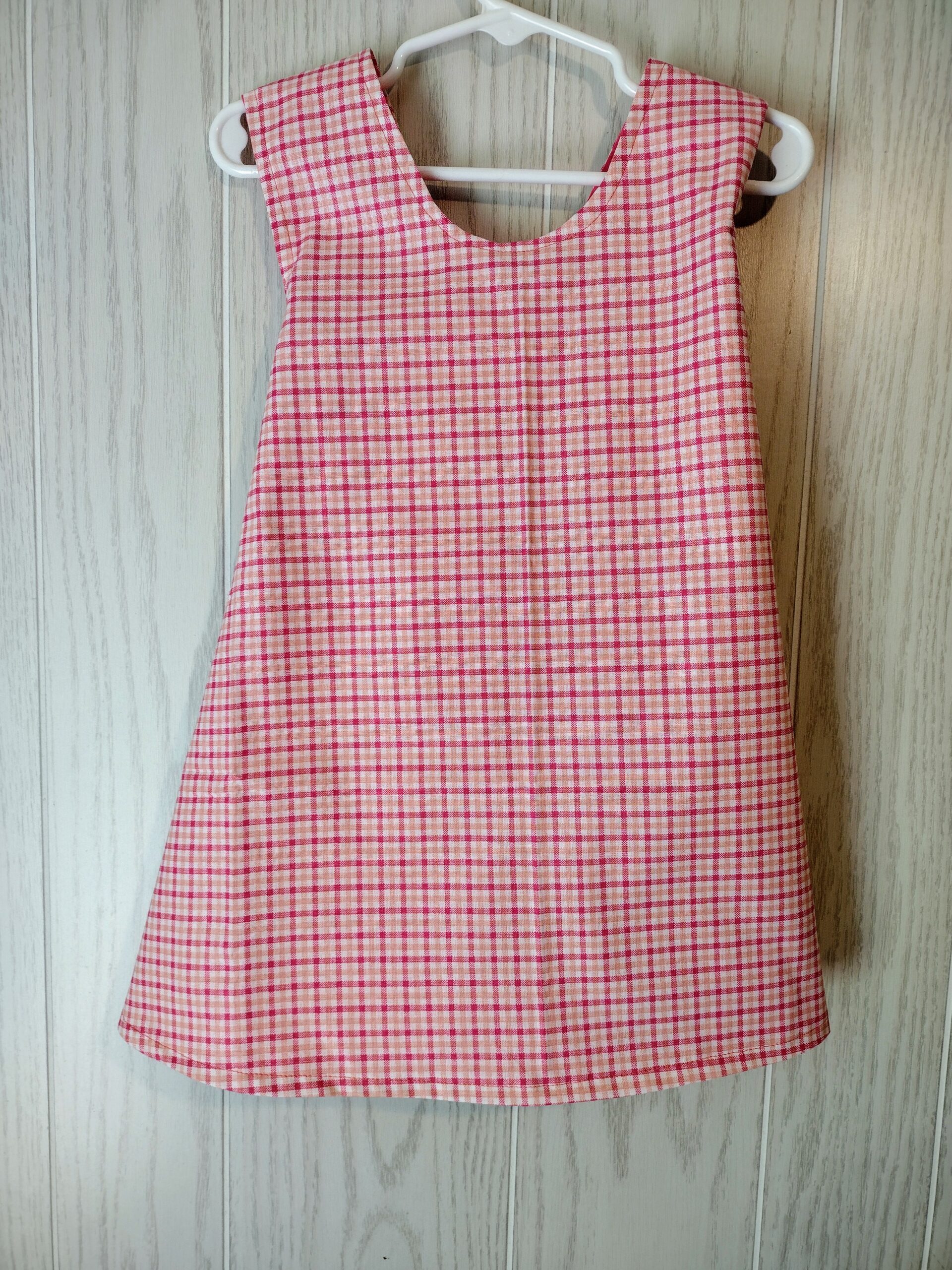 peach and pink plaid criss cross pinafore dress